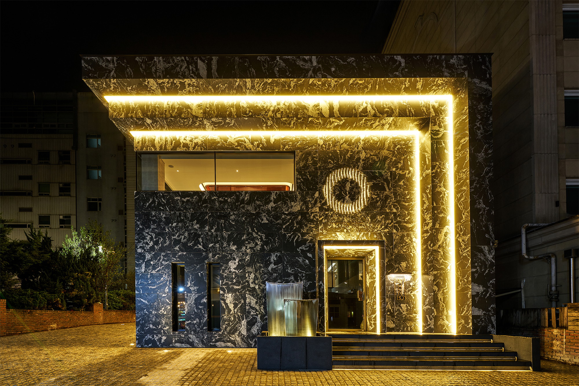 Graphic of a typography specimen showing the alphabet and numerals on top of a dark gray background.