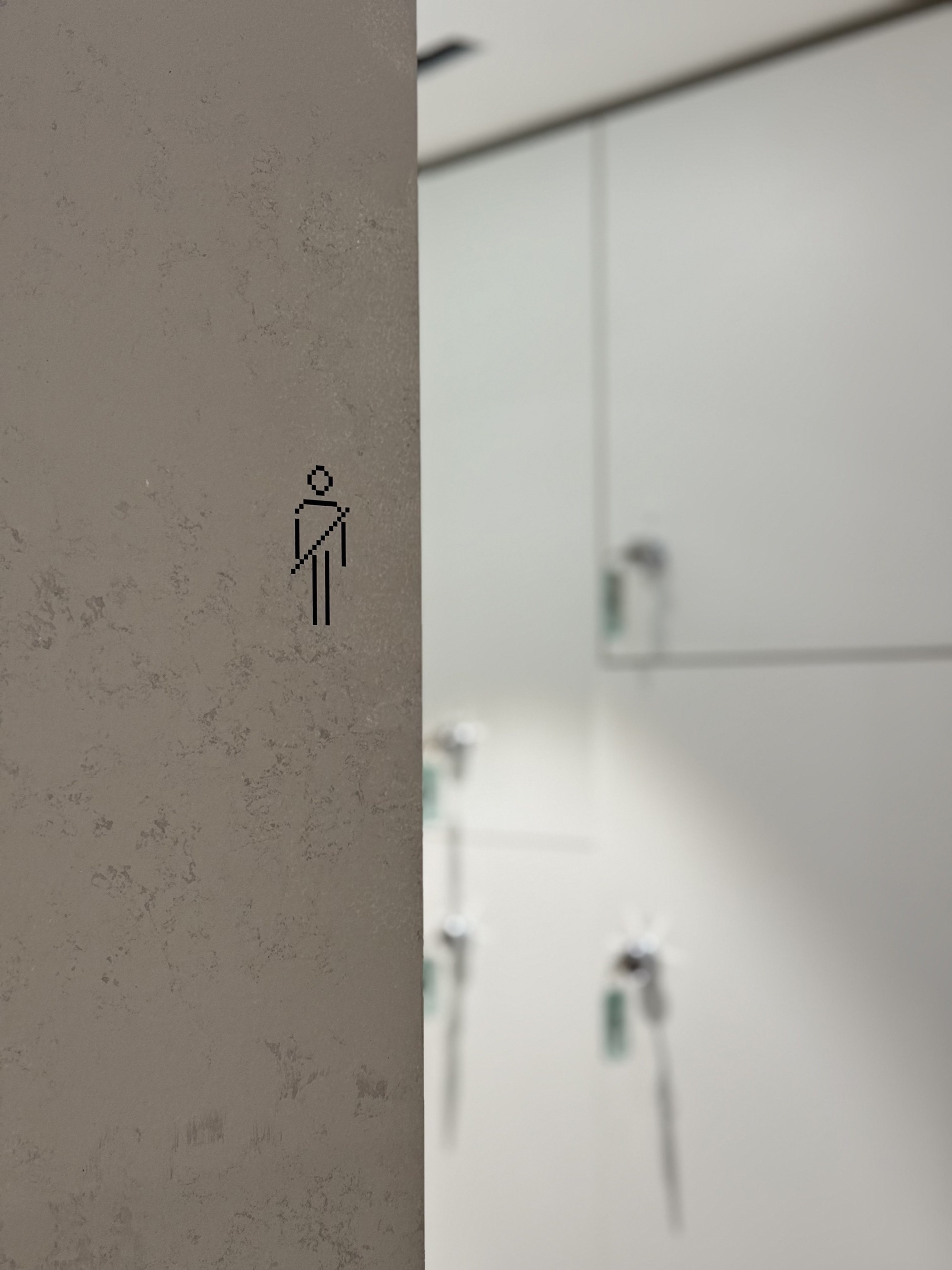 Graphic of a typography specimen showing the alphabet and numerals on top of a dark gray background.