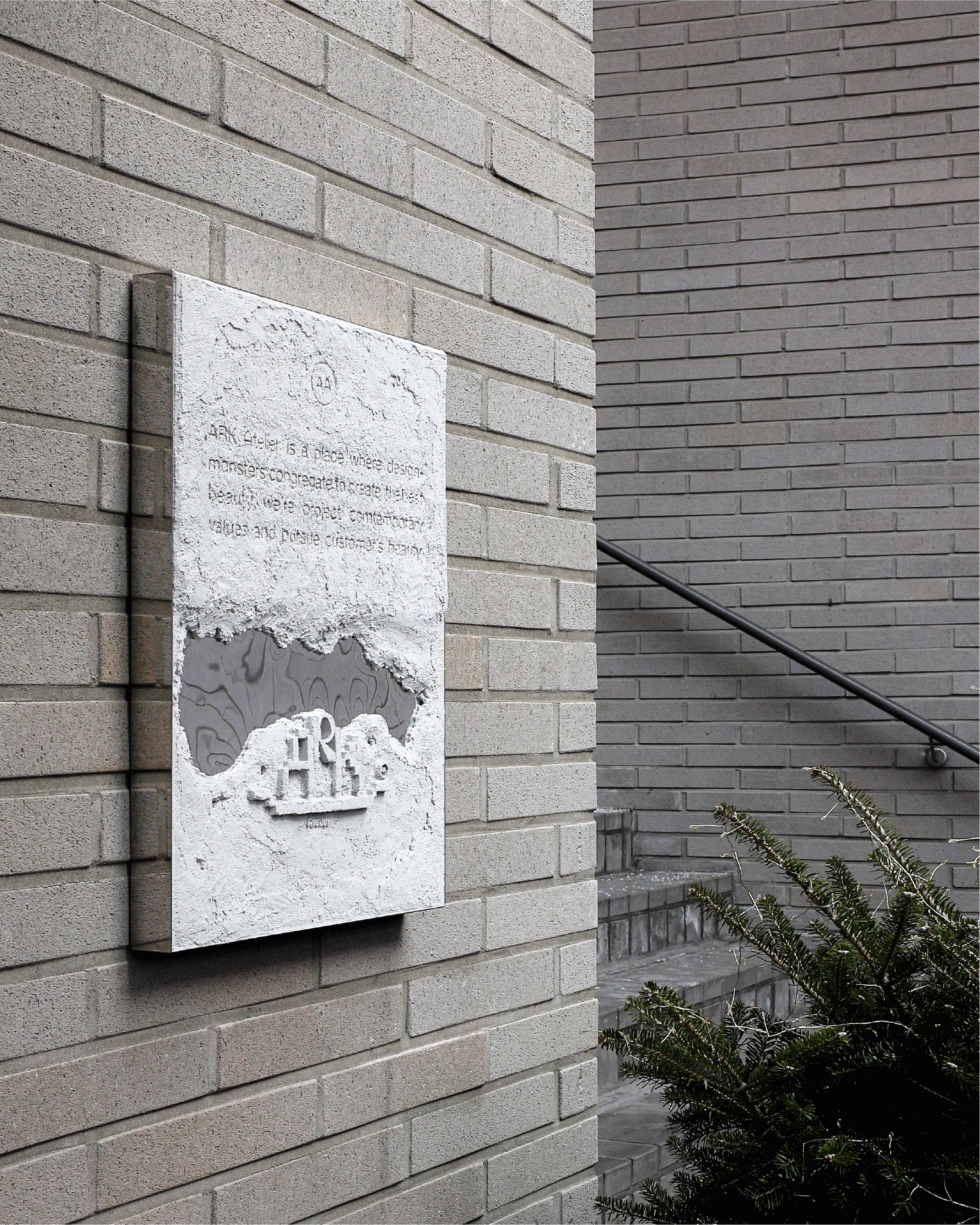 Graphic of a typography specimen showing the alphabet and numerals on top of a dark gray background.