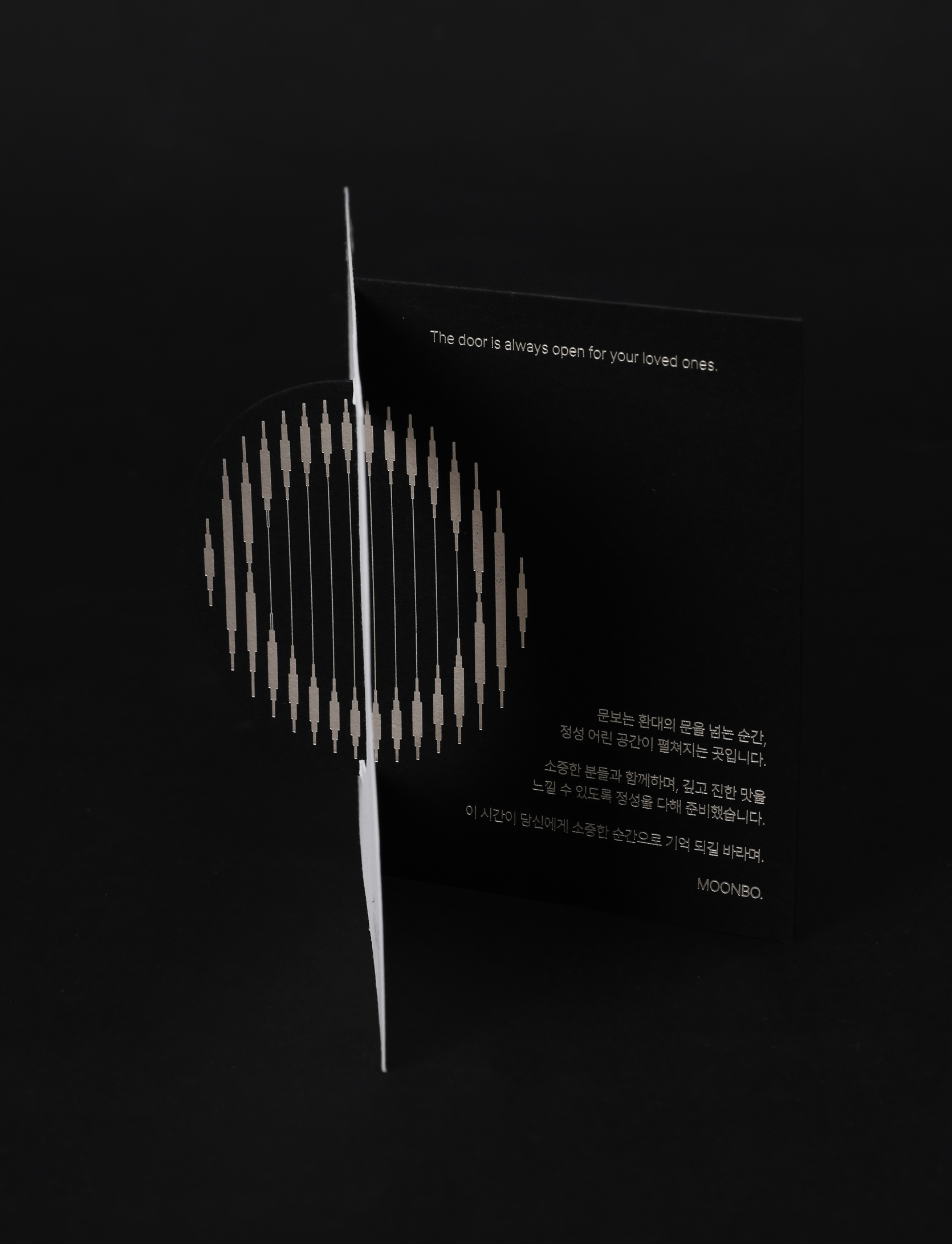 Graphic of a typography specimen showing the alphabet and numerals on top of a dark gray background.